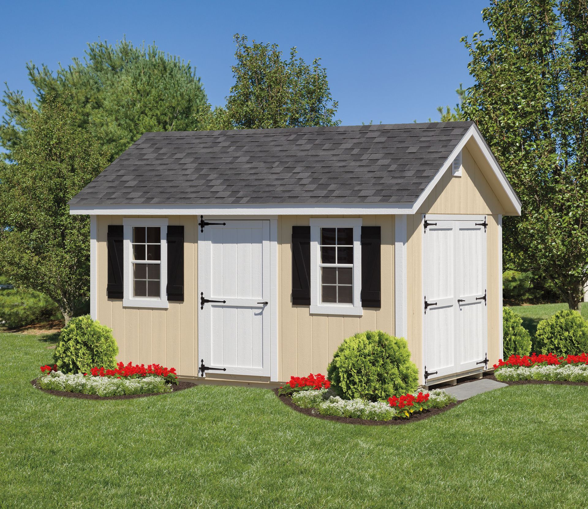 Tan wooden shed with black shutters and dark gray roof in a garden.