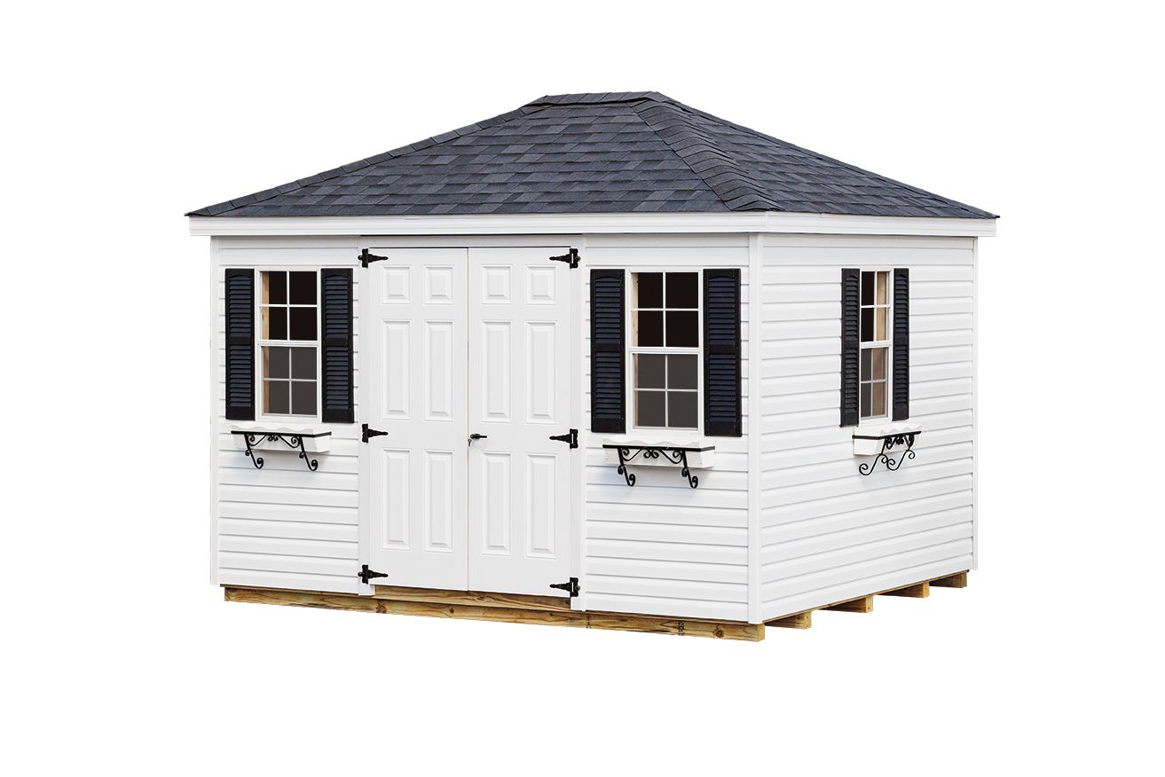 White shed with black shutters and roof, built on a wood base, against a white background.