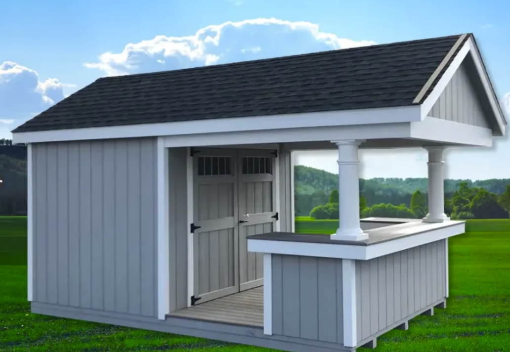Gray shed with bar, white trim, and dark gray roof, on a green lawn.