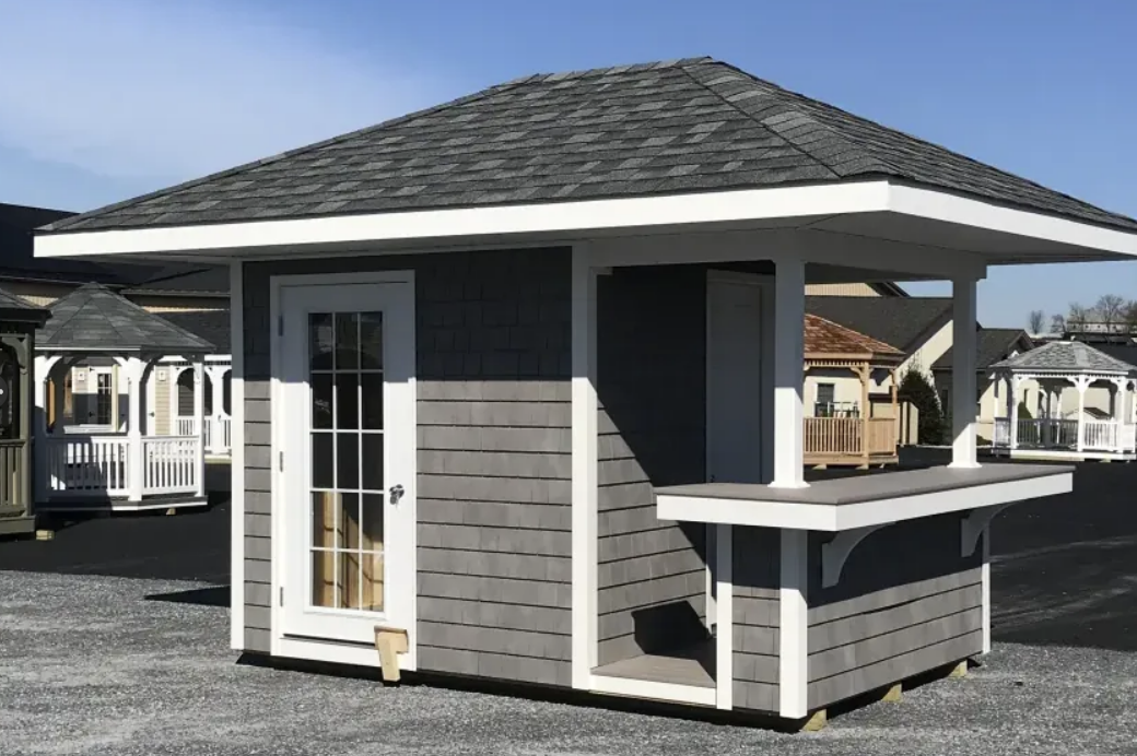 Gray outdoor bar with a white trim and dark gray roof.