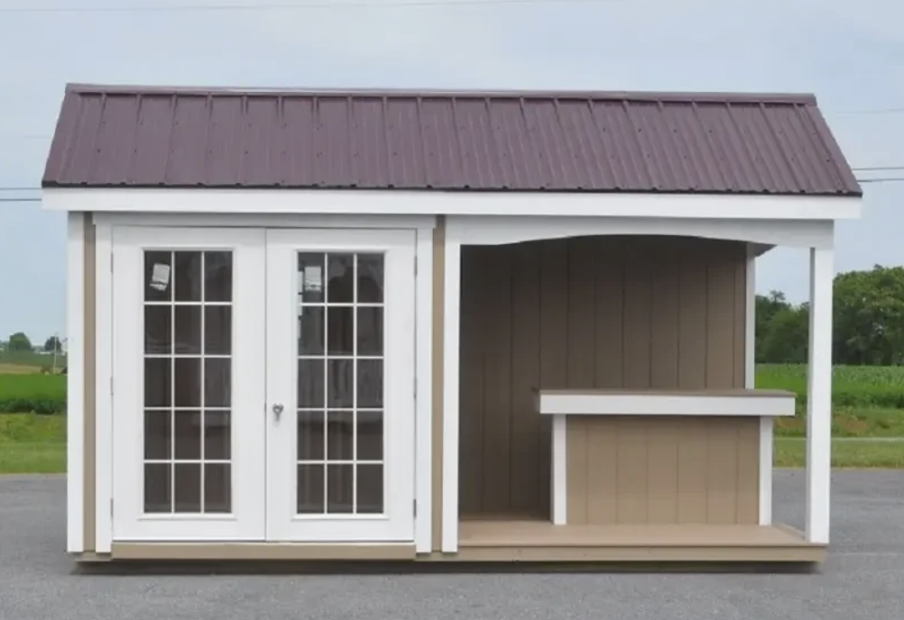 Brown-roofed shed with double glass doors, white trim, and a small counter.