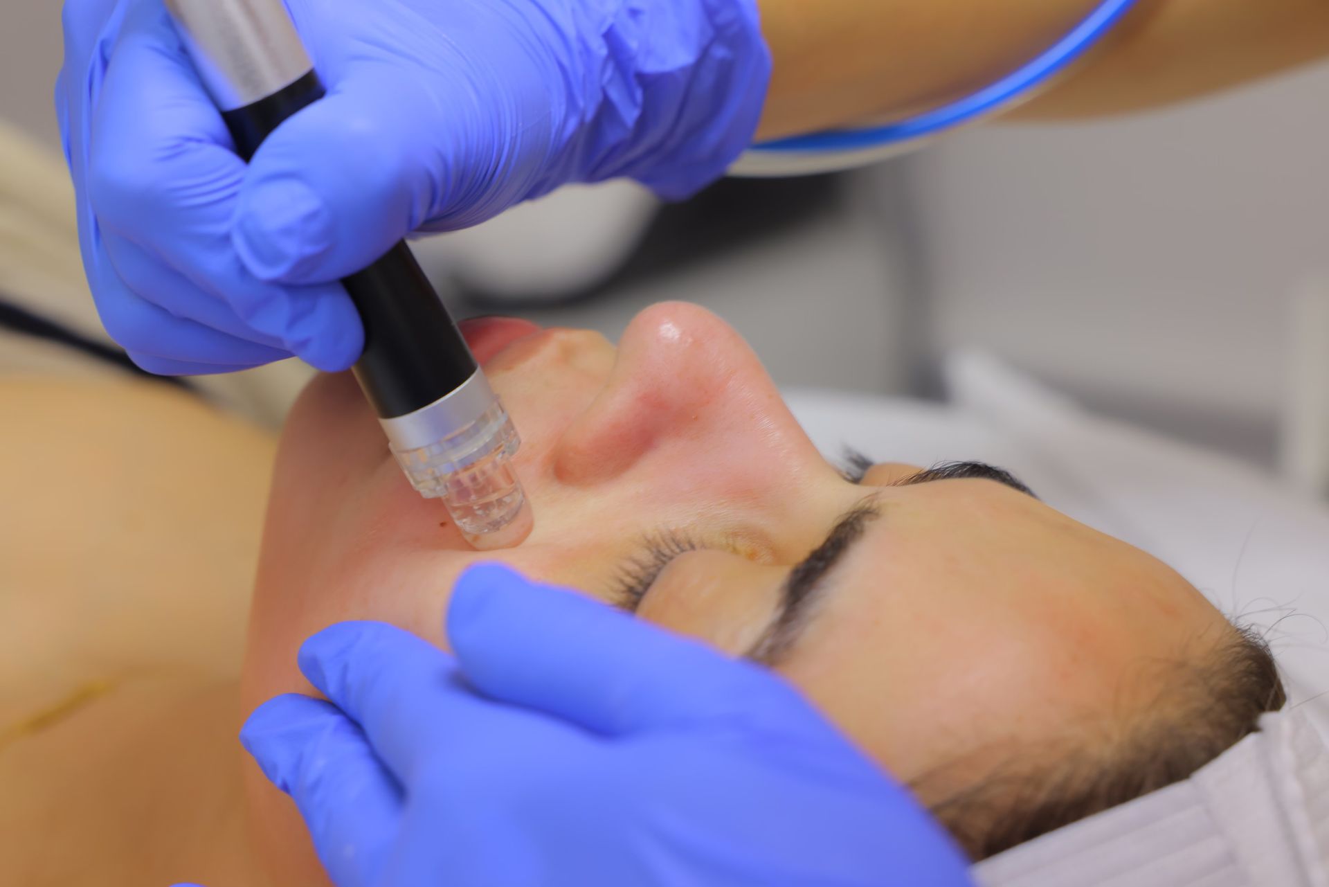 A woman is getting a facial treatment at a beauty salon.