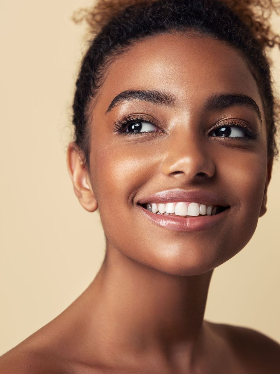 A close up of a woman 's face with a smile on her face.