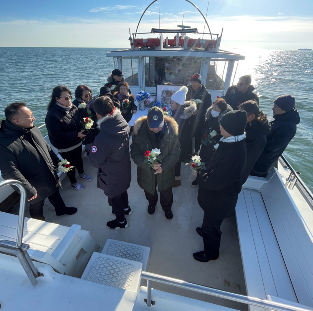 A group of people are on a boat in the ocean