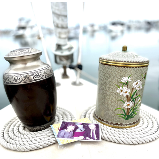 Two vases are sitting on a rope mat on a table