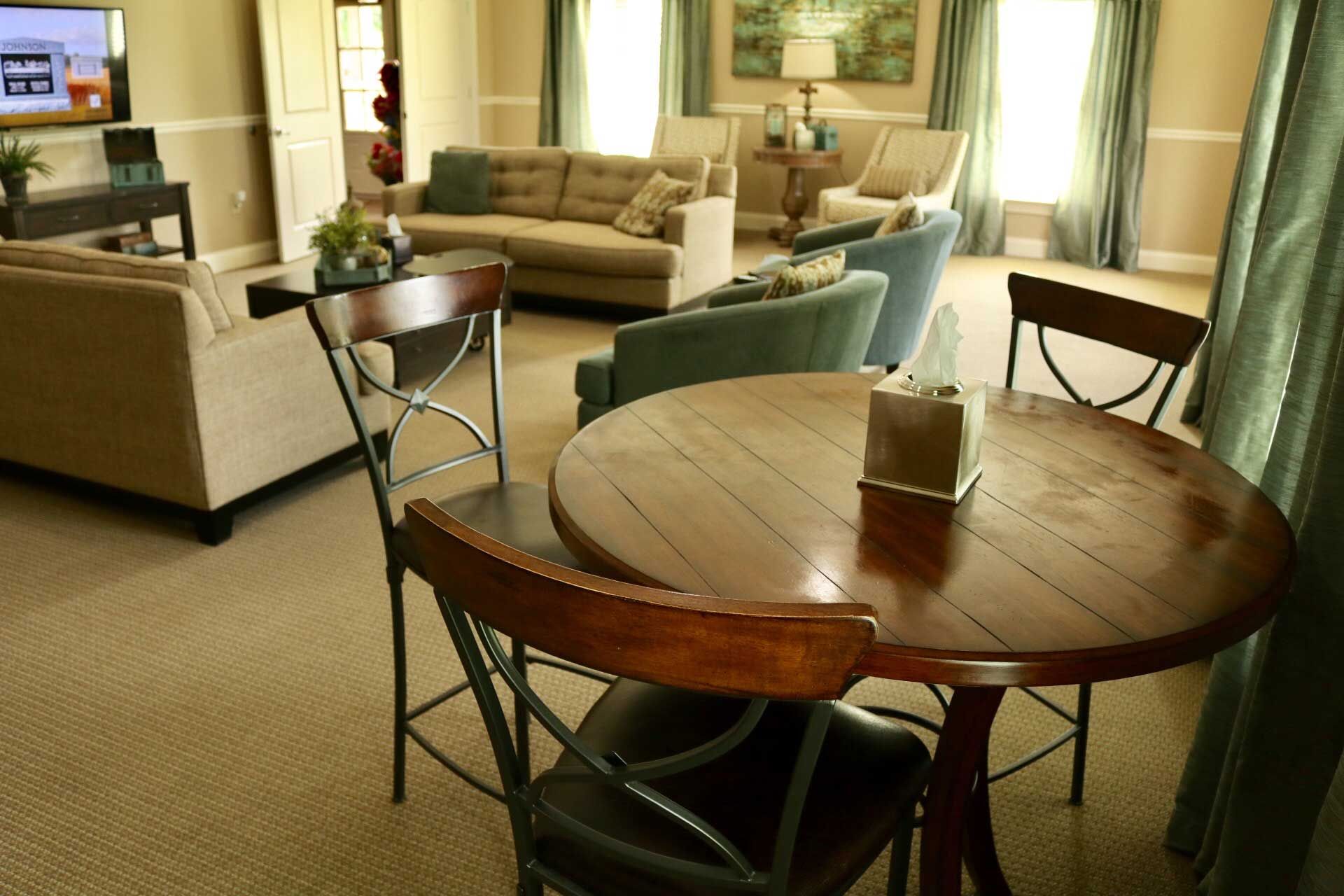 A living room with a round table and chairs