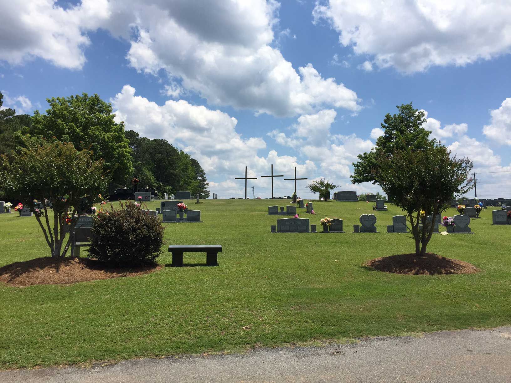 A cemetery with a bench in the middle of it