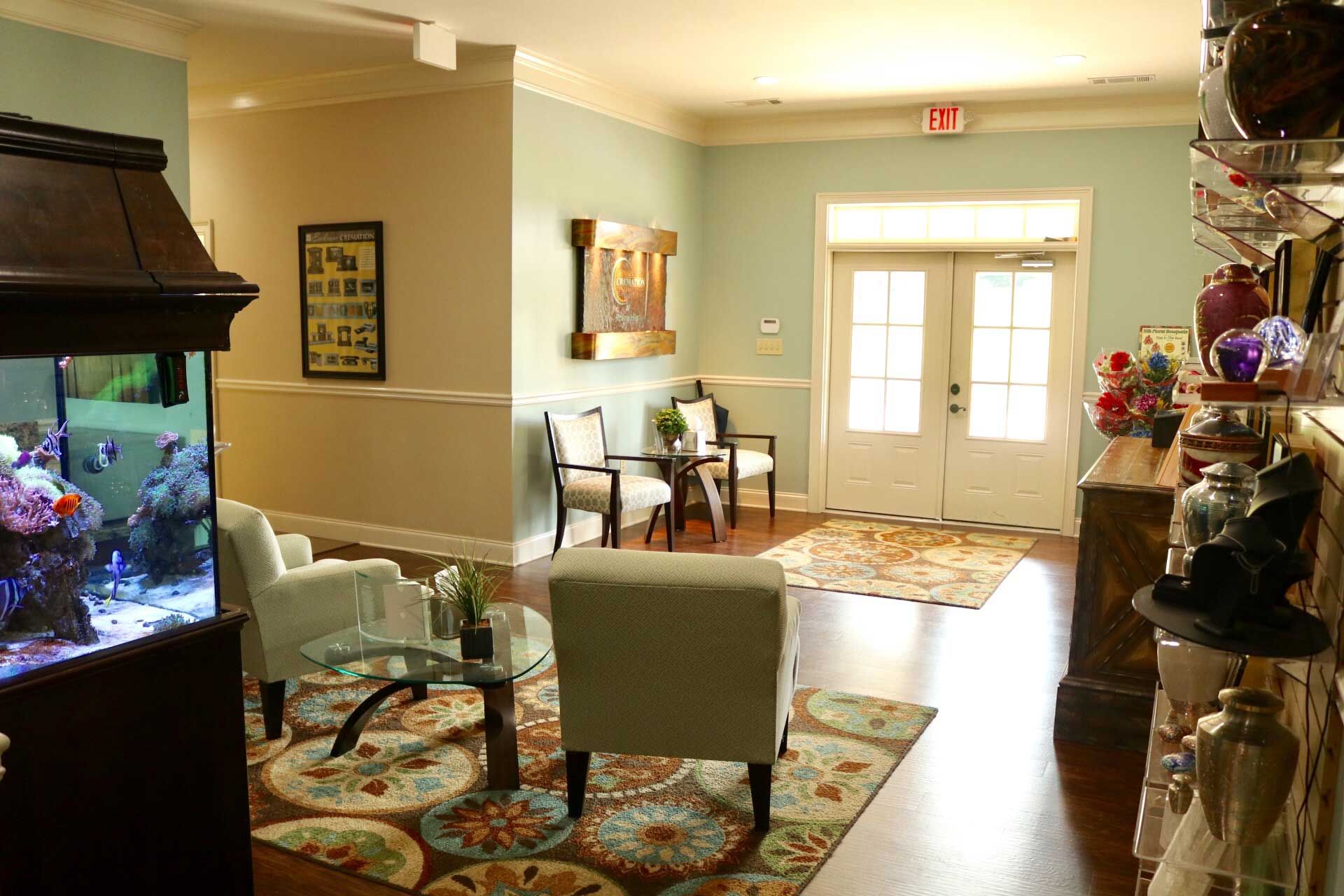 A living room with chairs and a fish tank