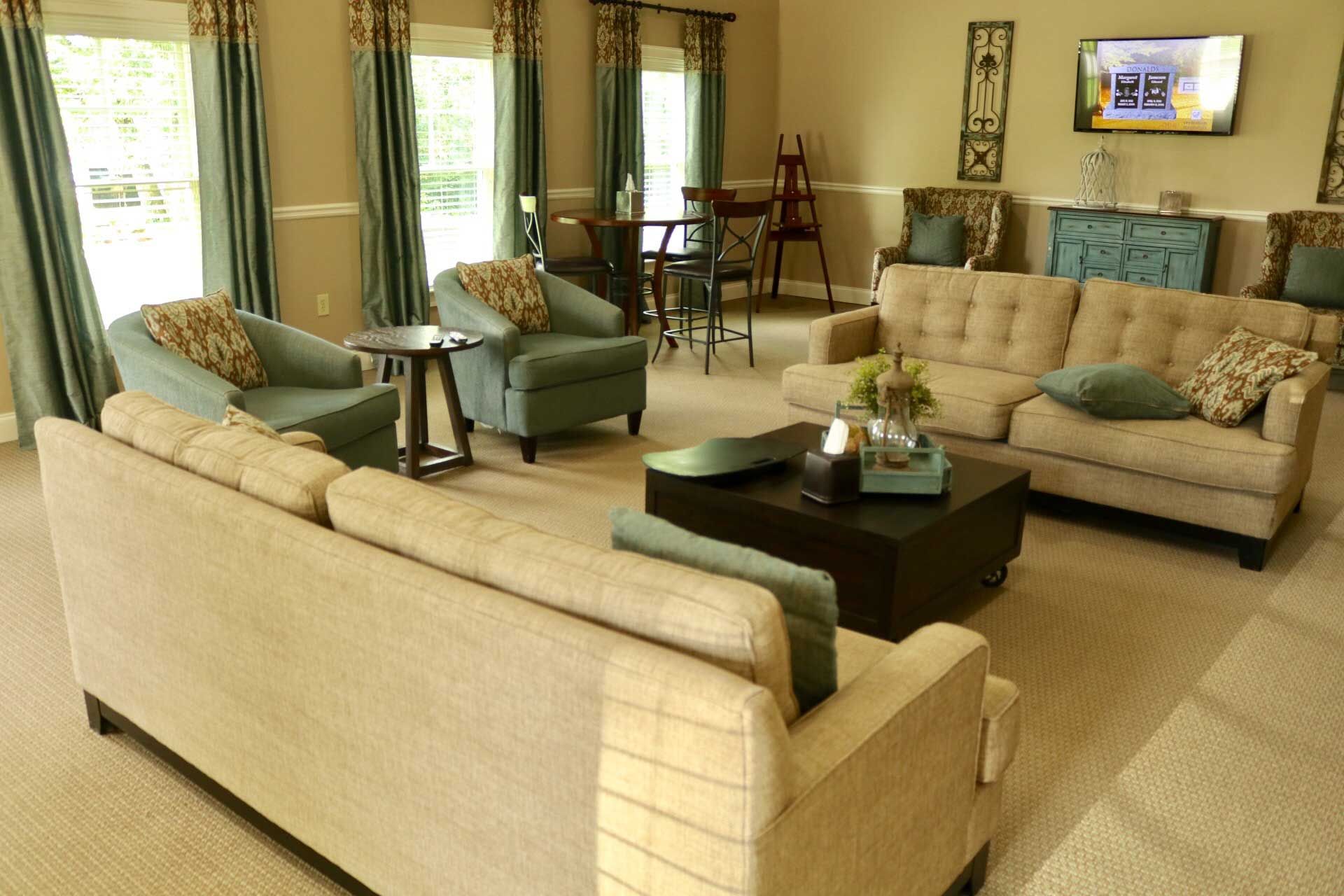 A living room filled with furniture and a television.