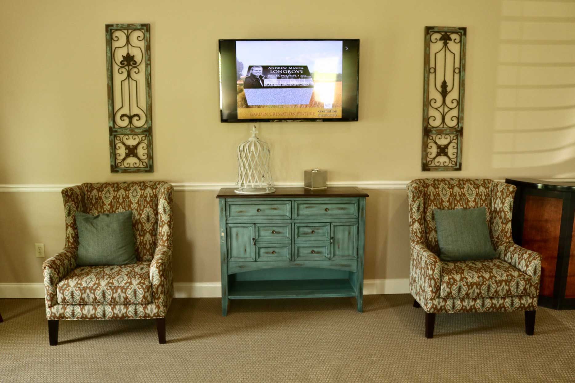 A living room with two chairs and a flat screen tv