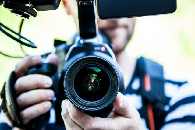 A man is taking a picture with a camera.