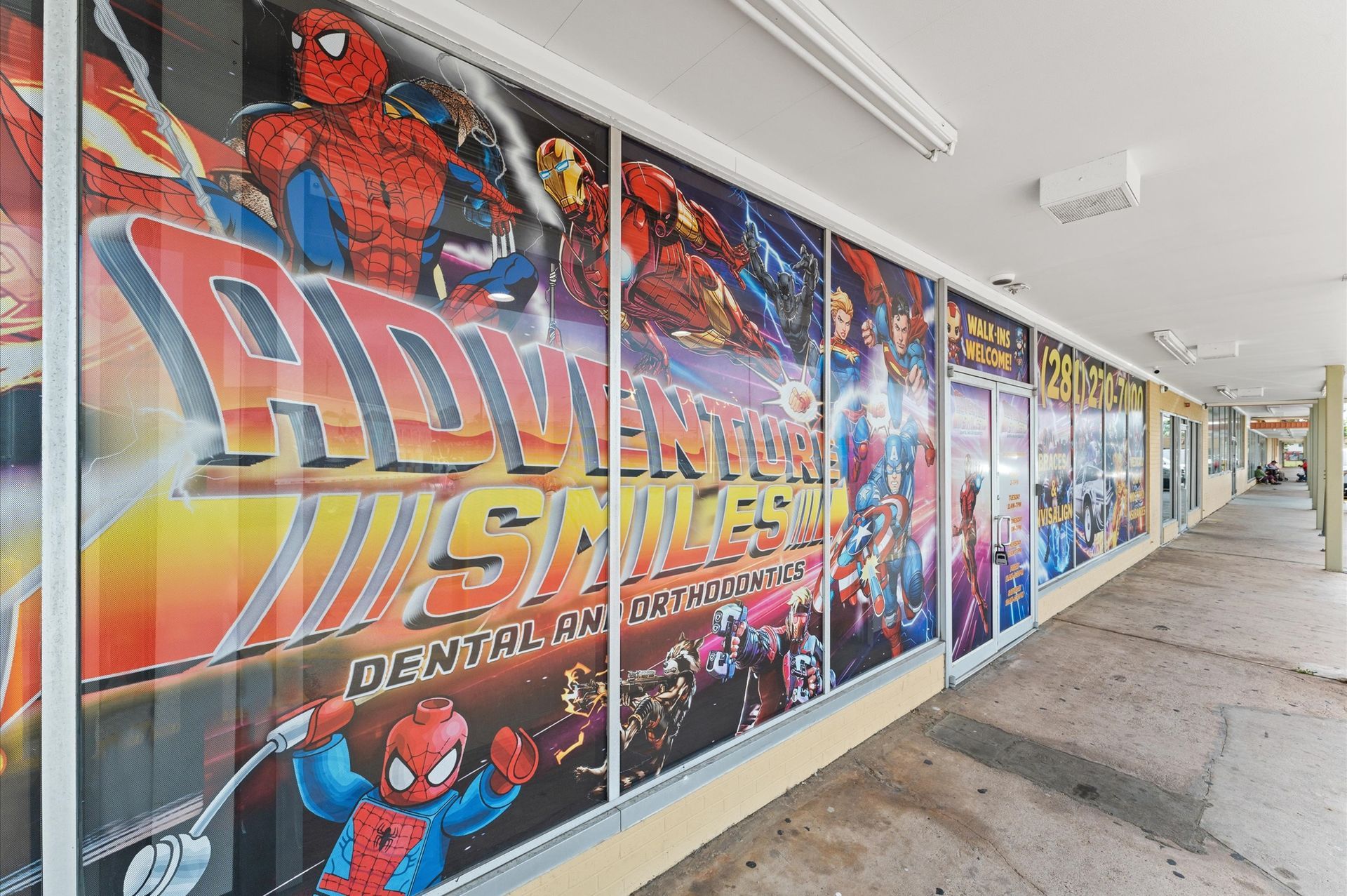 Adventure Smiles Dental & Orthodontics in Houston - A store front with a spider man advertisement on it