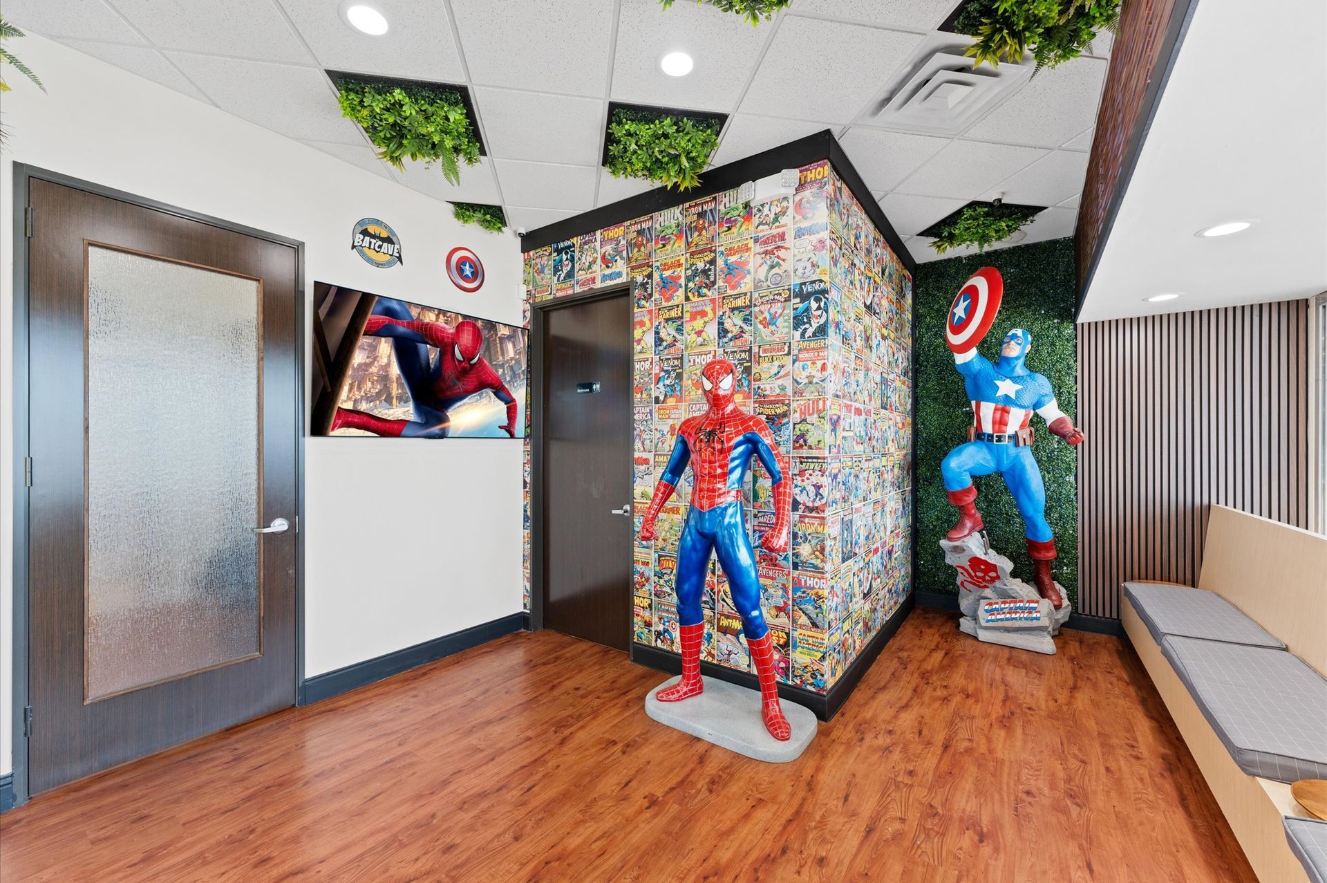 Adventure Smiles Dental & Orthodontics in Houston - A waiting room with two statues of spiderman and captain america.