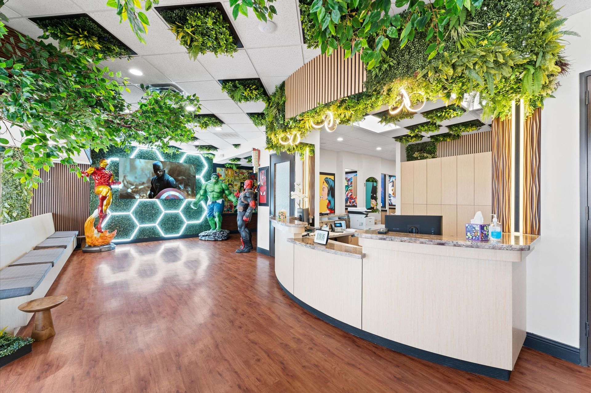 Adventure Smiles Dental & Orthodontics in Houston - A reception area of a dental office with plants hanging from the ceiling.