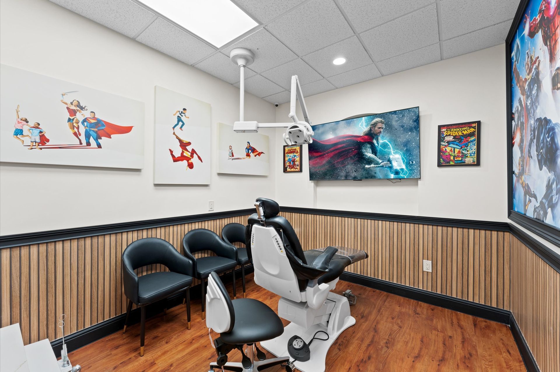 Adventure Smiles Dental & Orthodontics in Houston - A dental office with a dental chair and paintings on the wall.