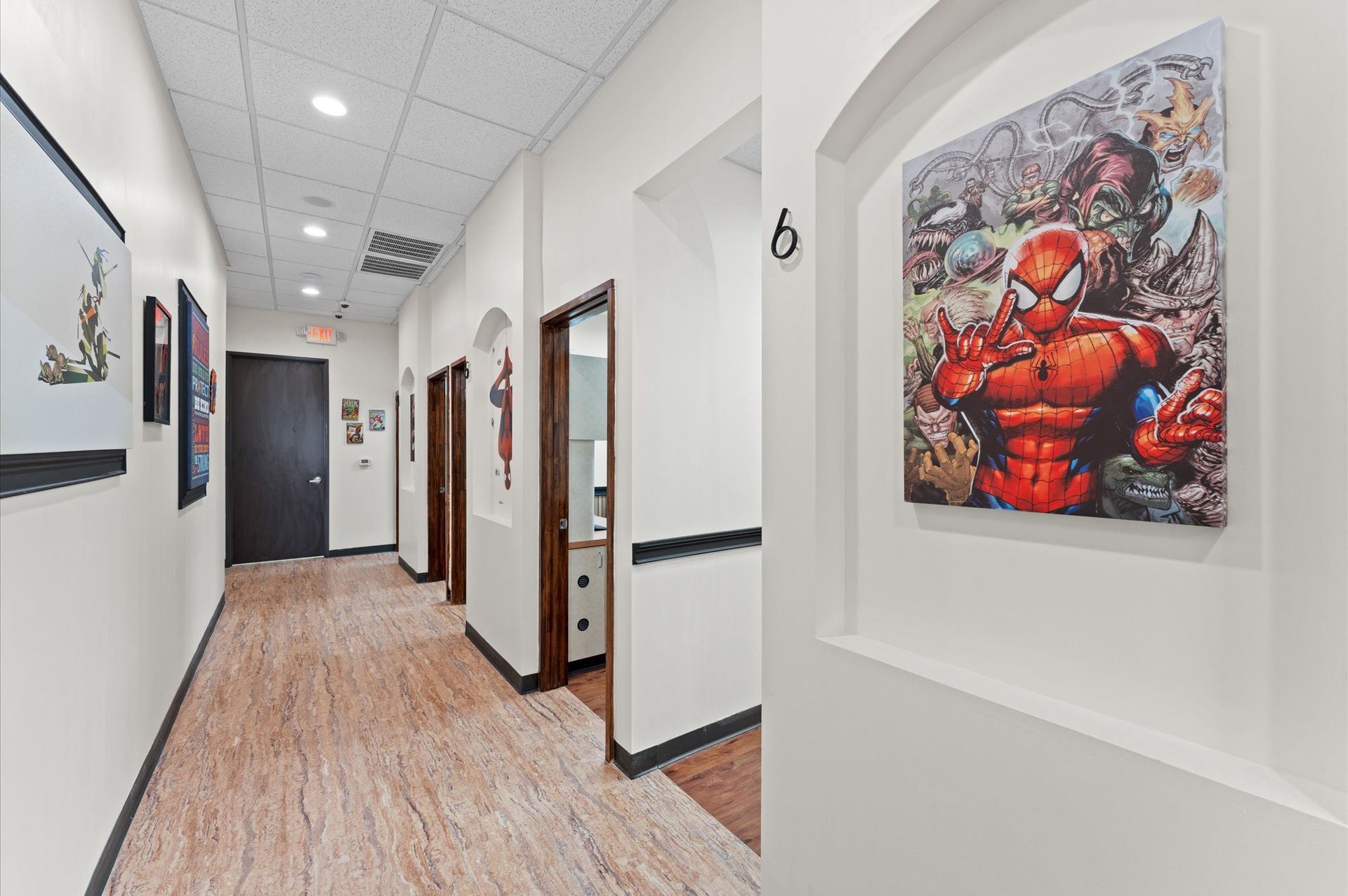 Adventure Smiles Dental & Orthodontics in Houston - A hallway with a painting of spider man on the wall