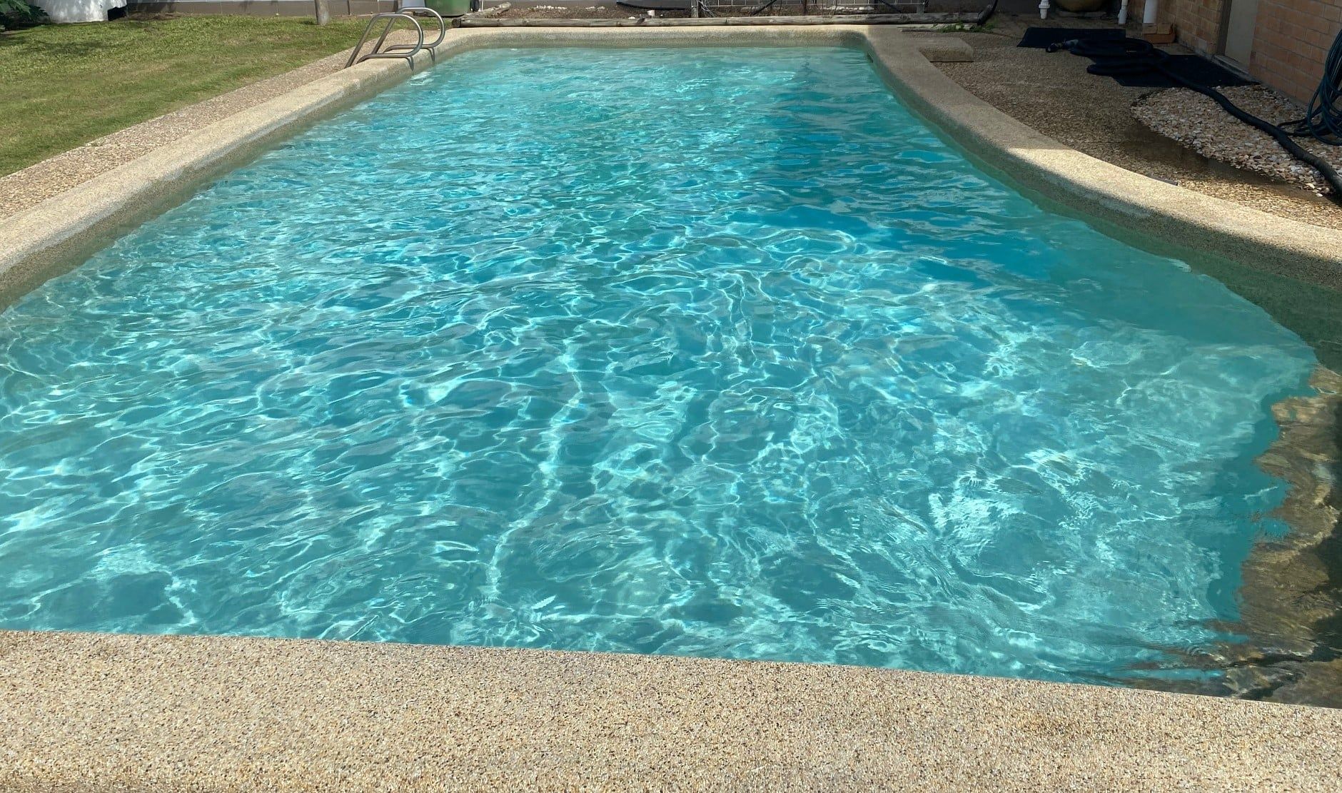 Rectangular swimming pool with clear, blue water — Ultra Clear Pool Care in Cranbrook, QLD