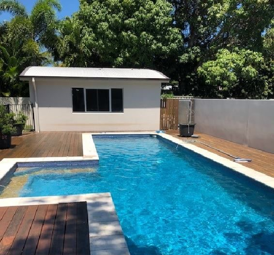 Bubbles Rising from A White and Black Circular Device in A Blue Swimming Pool — Ultra Clear Pool Care in Cranbrook, QLD