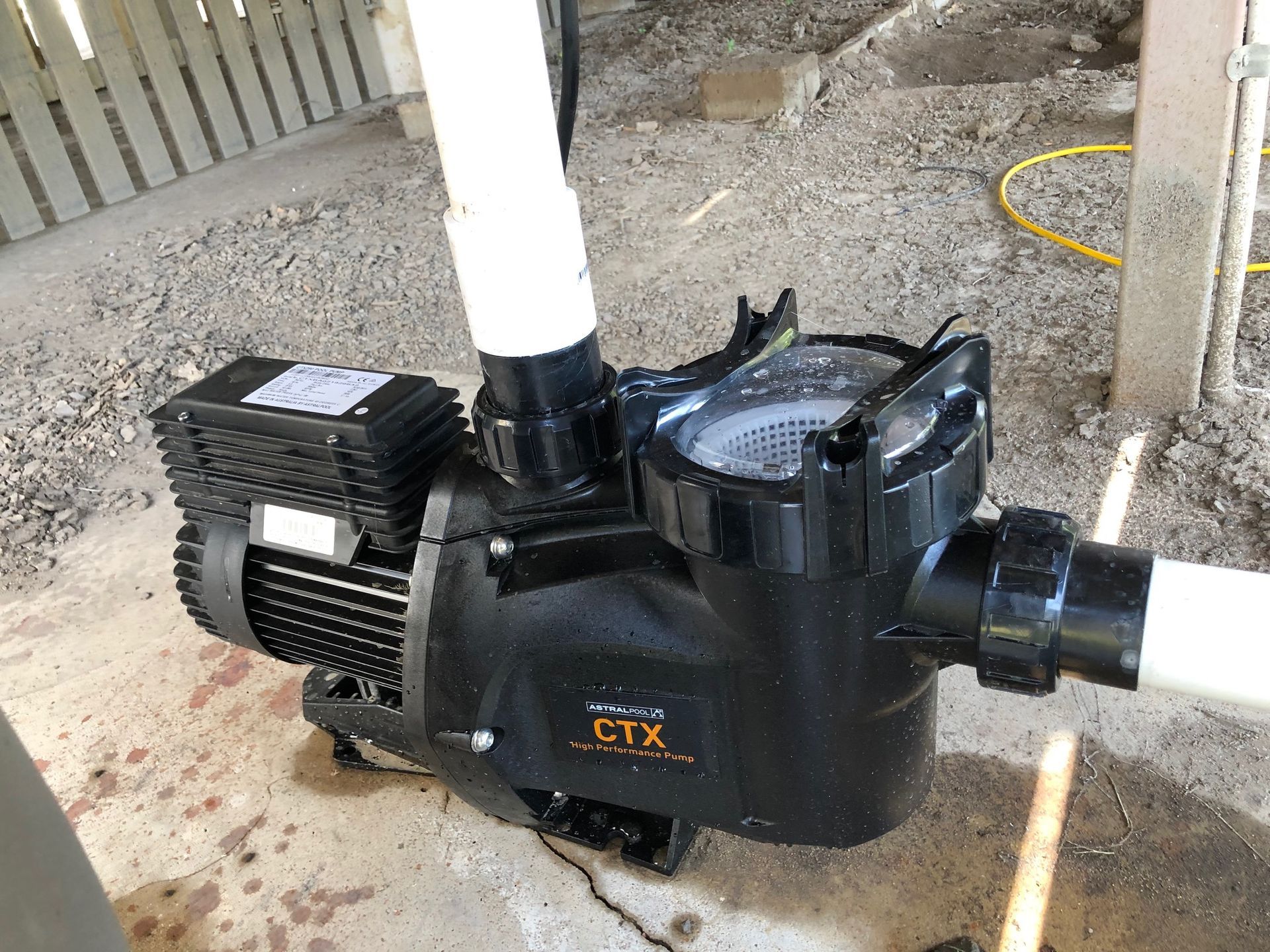 Black Pool Pump With White Pipes, Outdoors On Gravel — Ultra Clear Pool Care in Cranbrook, QLD