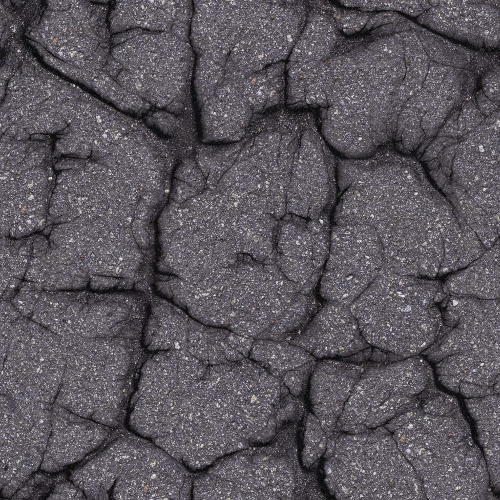Close-up of cracked, dark asphalt surface.