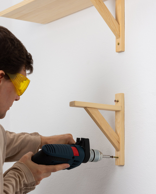 handyman installing new shelving for client