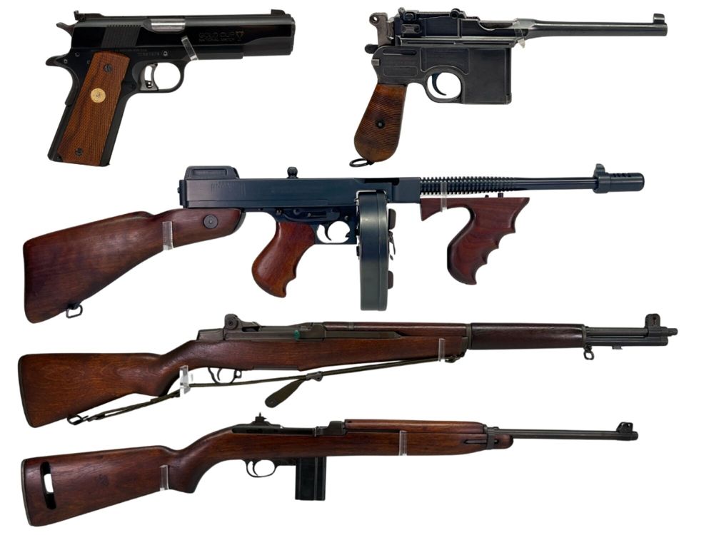 Five handguns and rifles with wooden grips and stocks displayed on a white background