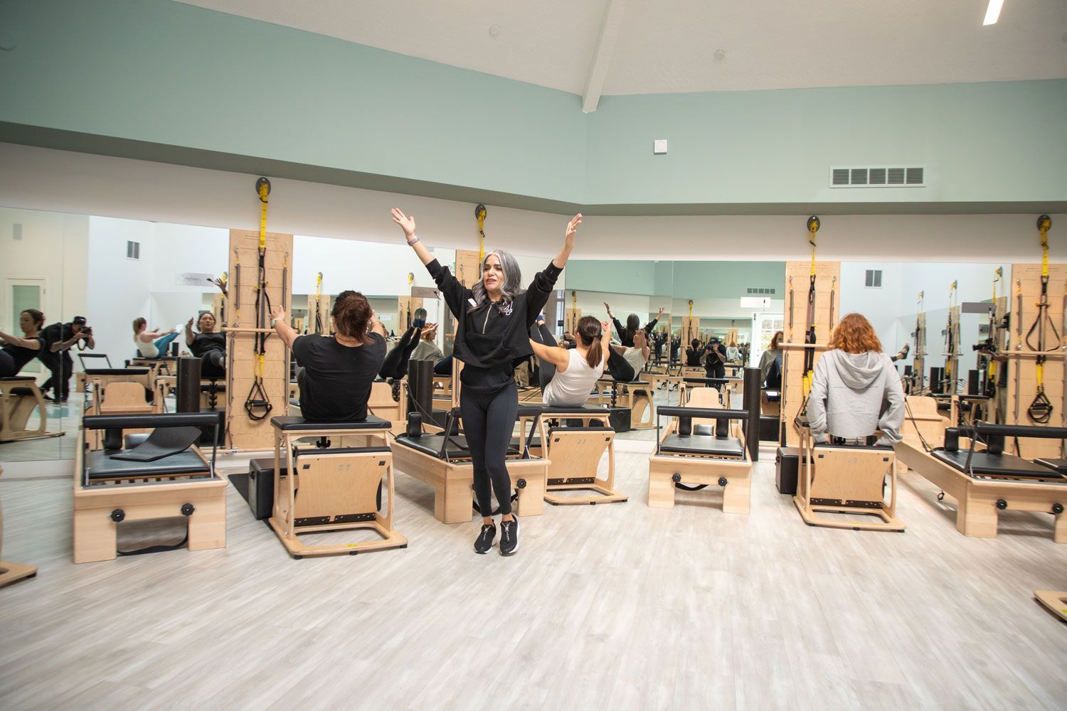 A group of people are doing pilates in a gym.
