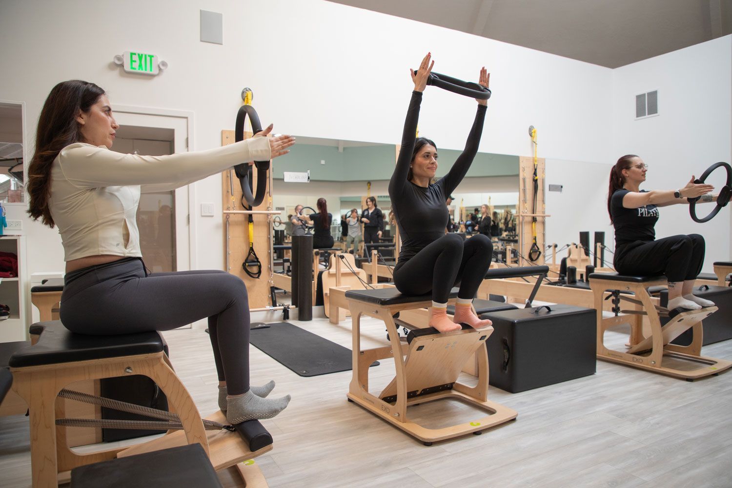 A group of women are doing pilates exercises in a gym.