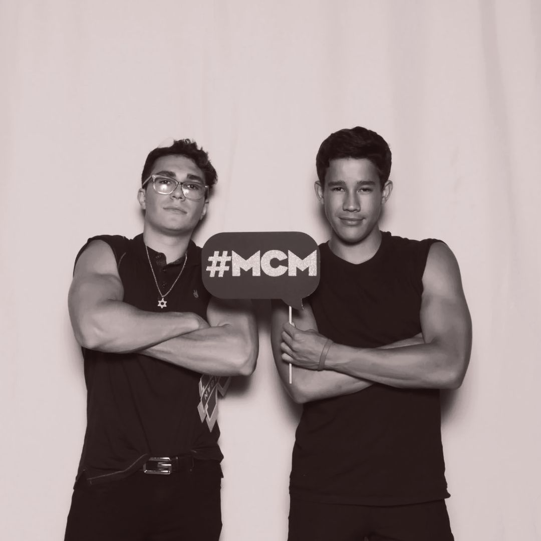 #MCM sign with two guys posing at the Ever After Glam Photo Booth during a graduation