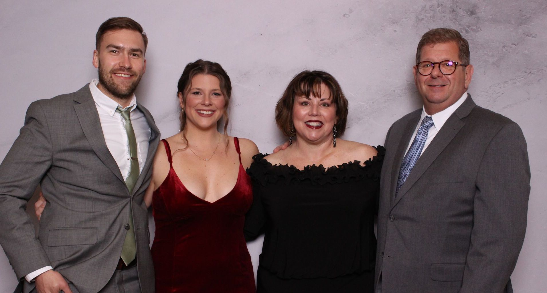 Couples at a non-profit gala event smiling at the Ever After Photo Booth