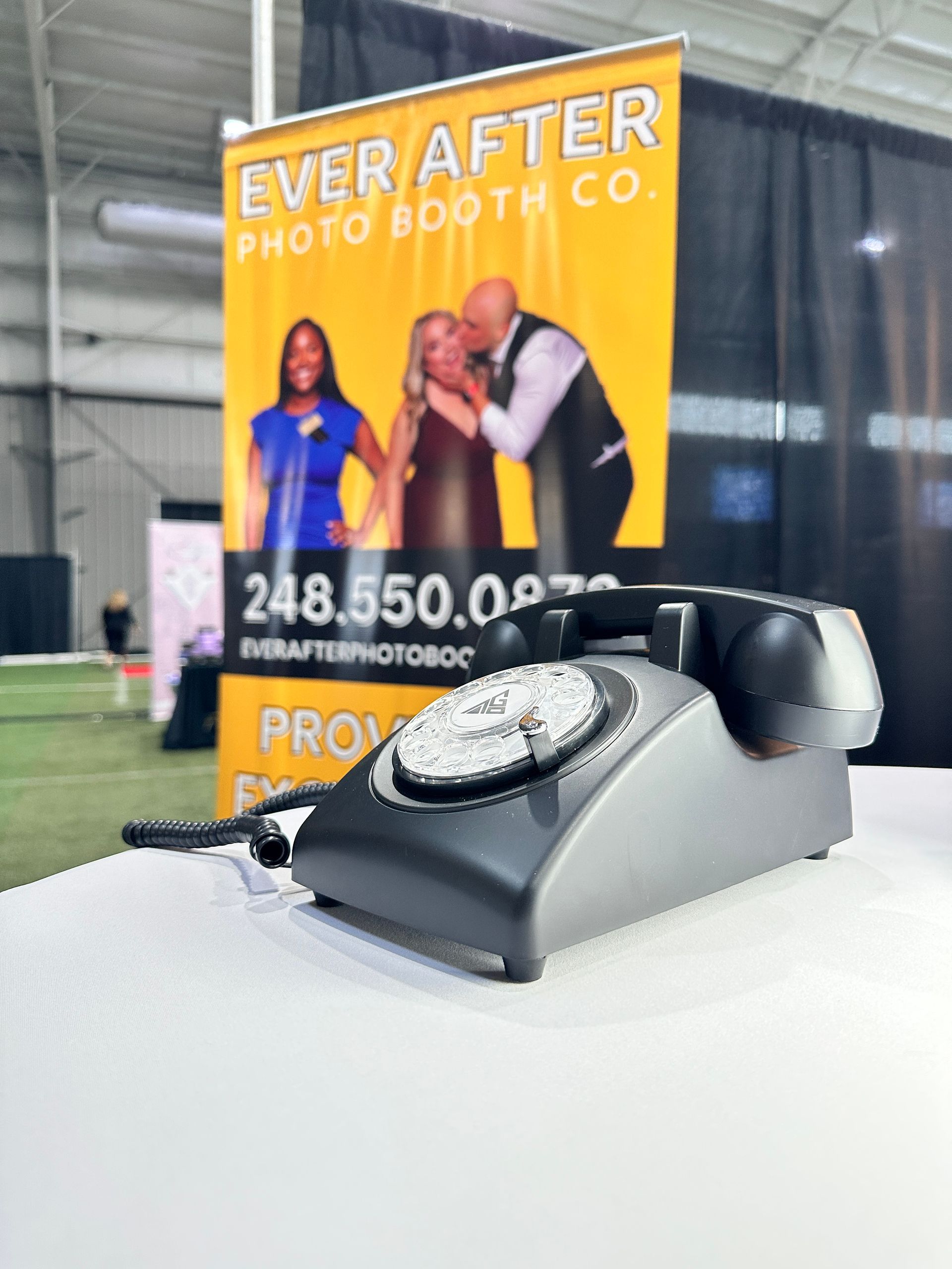 a phone is sitting on a table in front of a sign that says ever after photo booth co.