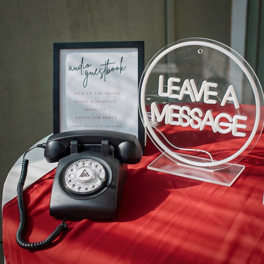 a sign that says leave a message next to an audio guestbook phone