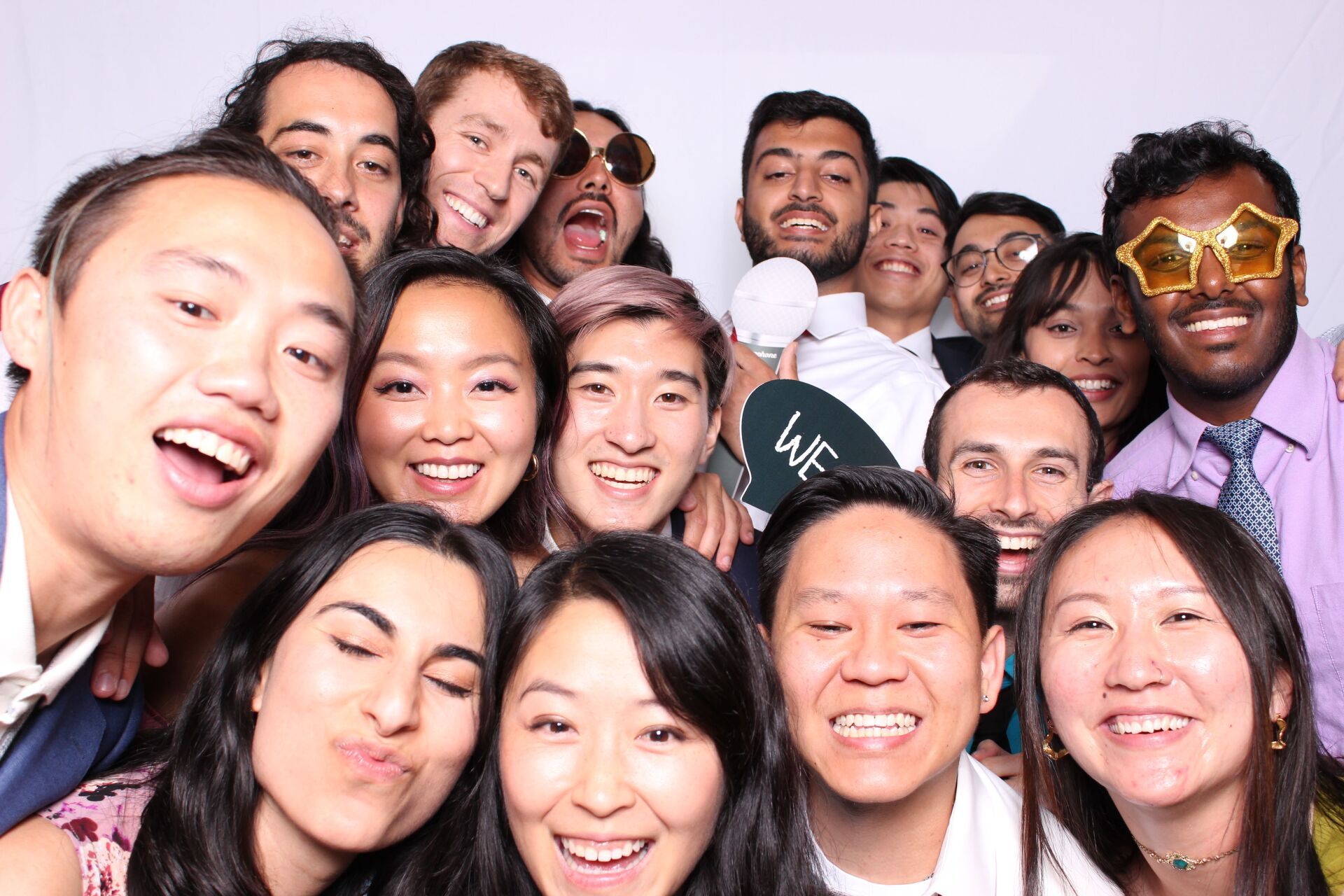 A group of people are posing for a picture in a photo booth.