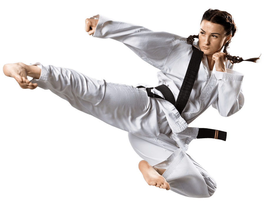 A woman in a karate uniform is kicking in the air.