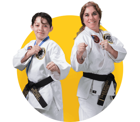 A woman and a boy are standing next to each other in karate uniforms.