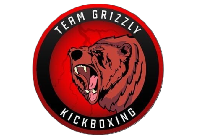 A logo for team grizzly kickboxing with a bear