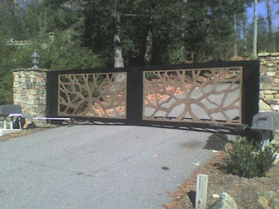 A gate that has a tree design on it