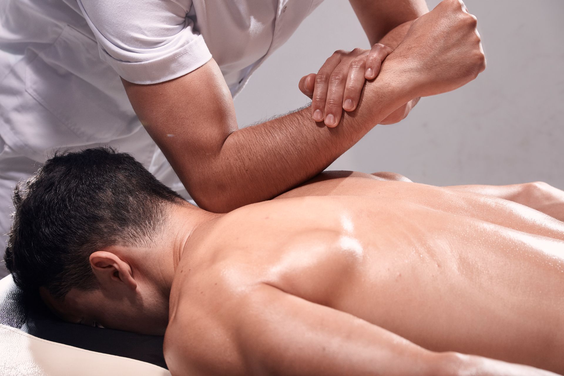 A man is getting a massage from a massage therapist.