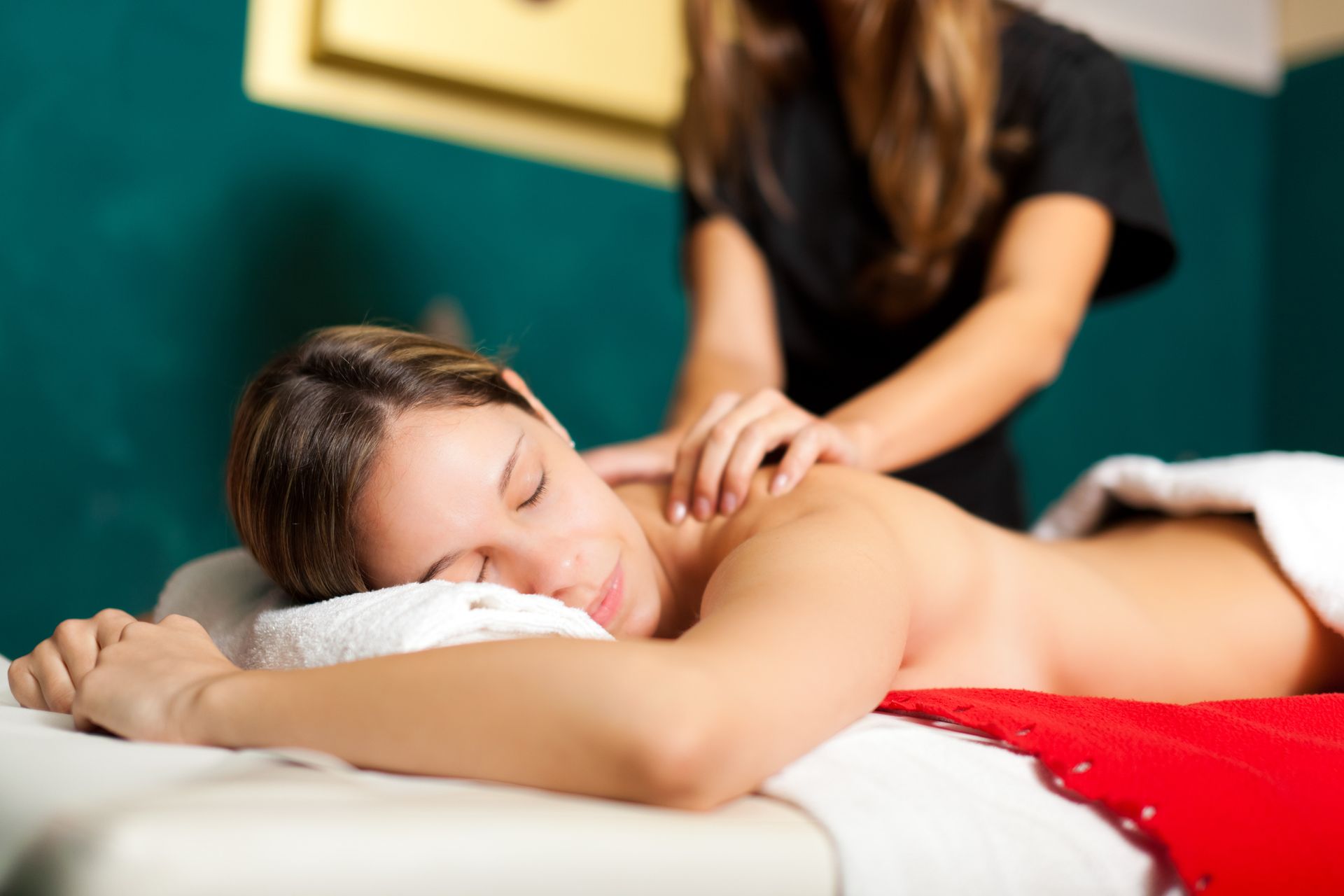 A woman is laying on a massage table getting a massage.