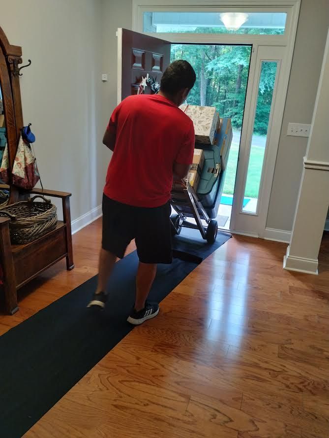 A man is pushing a stroller in a hallway.