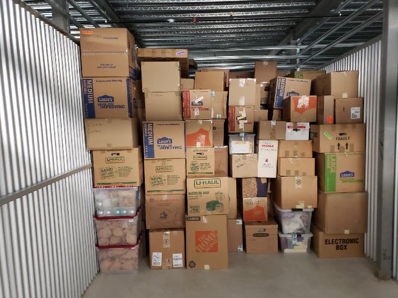 A warehouse filled with lots of boxes including a home depot box