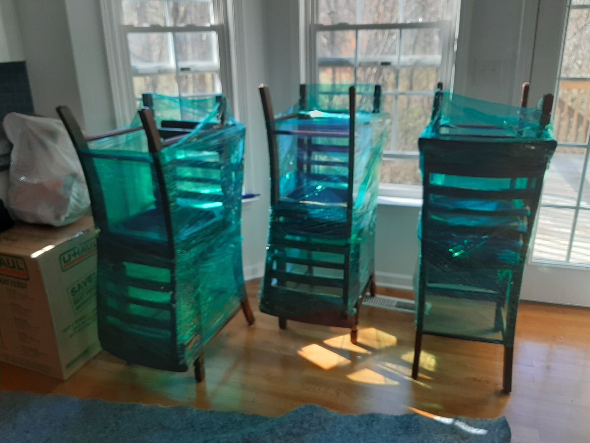 Three chairs are stacked on top of each other in a room.