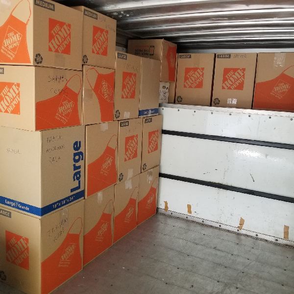 A stack of home depot boxes are stacked on top of each other