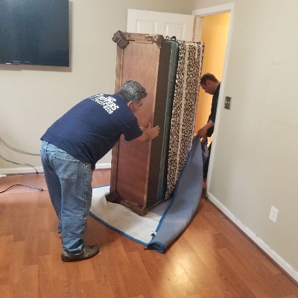 A man in a blue shirt with the word moving on his back