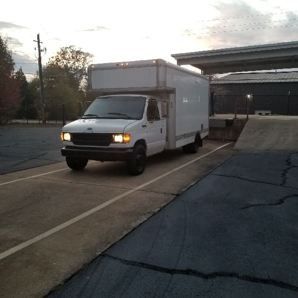 A white truck is parked on the side of the road