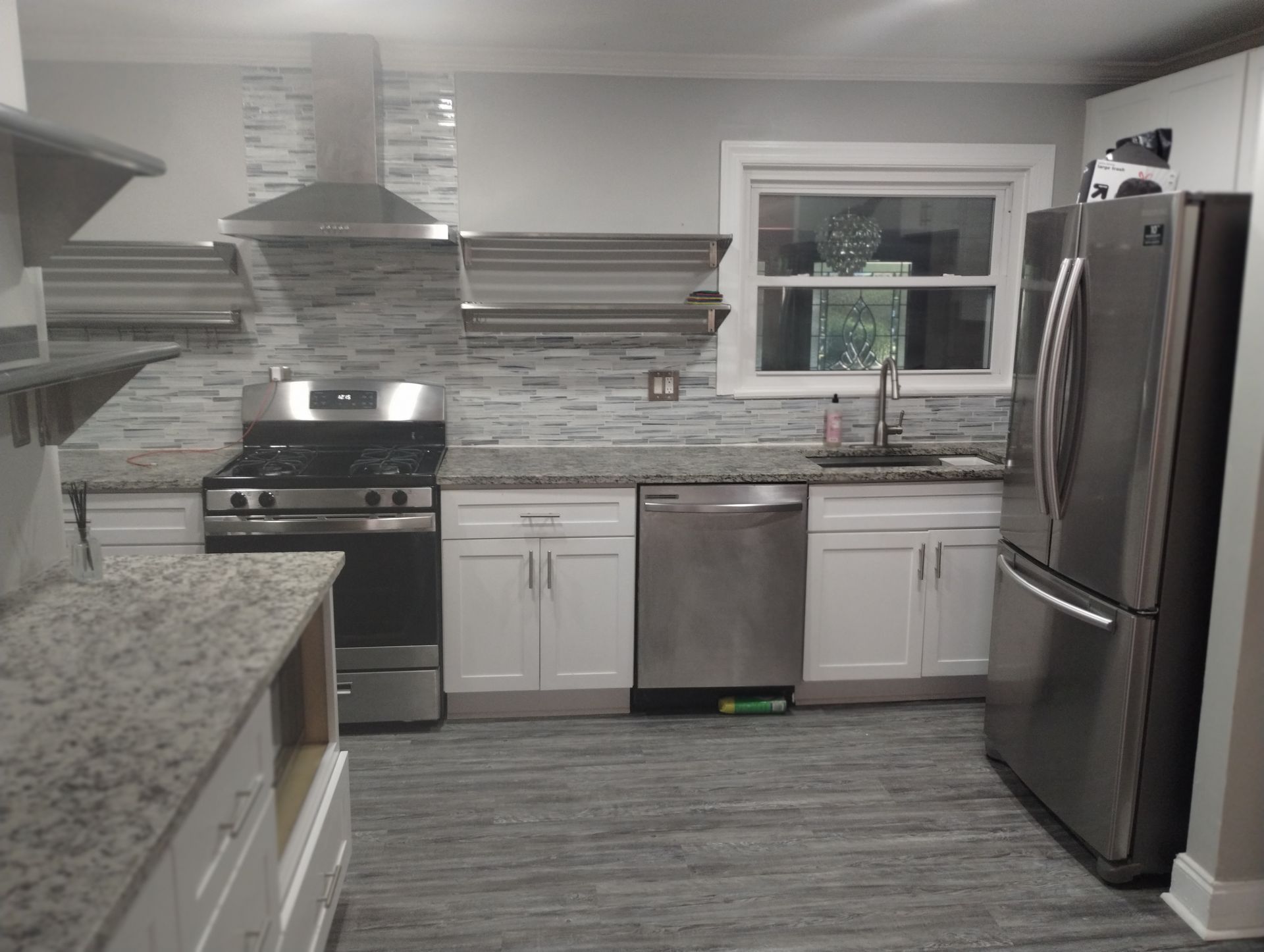 A kitchen with stainless steel appliances and granite counter tops
