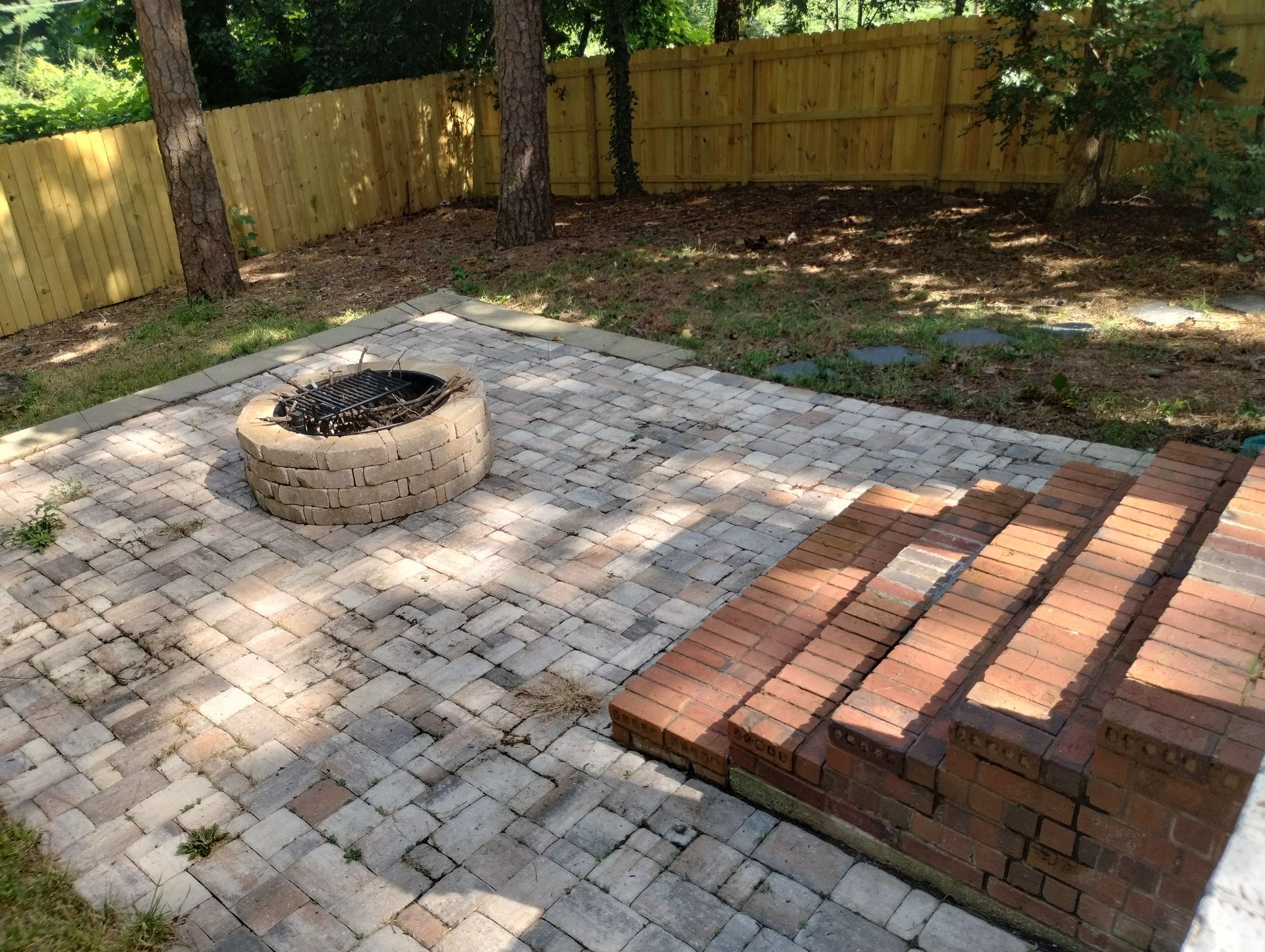 There is a fire pit in the middle of the patio.
