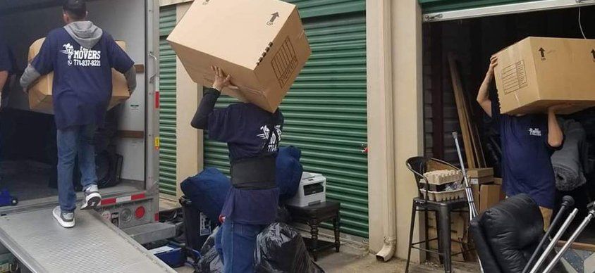 A group of people are carrying boxes on their heads.