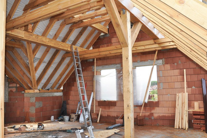Building Attic Interior. Roofing Construction Indoor. Wooden Roof Frame House Construction.