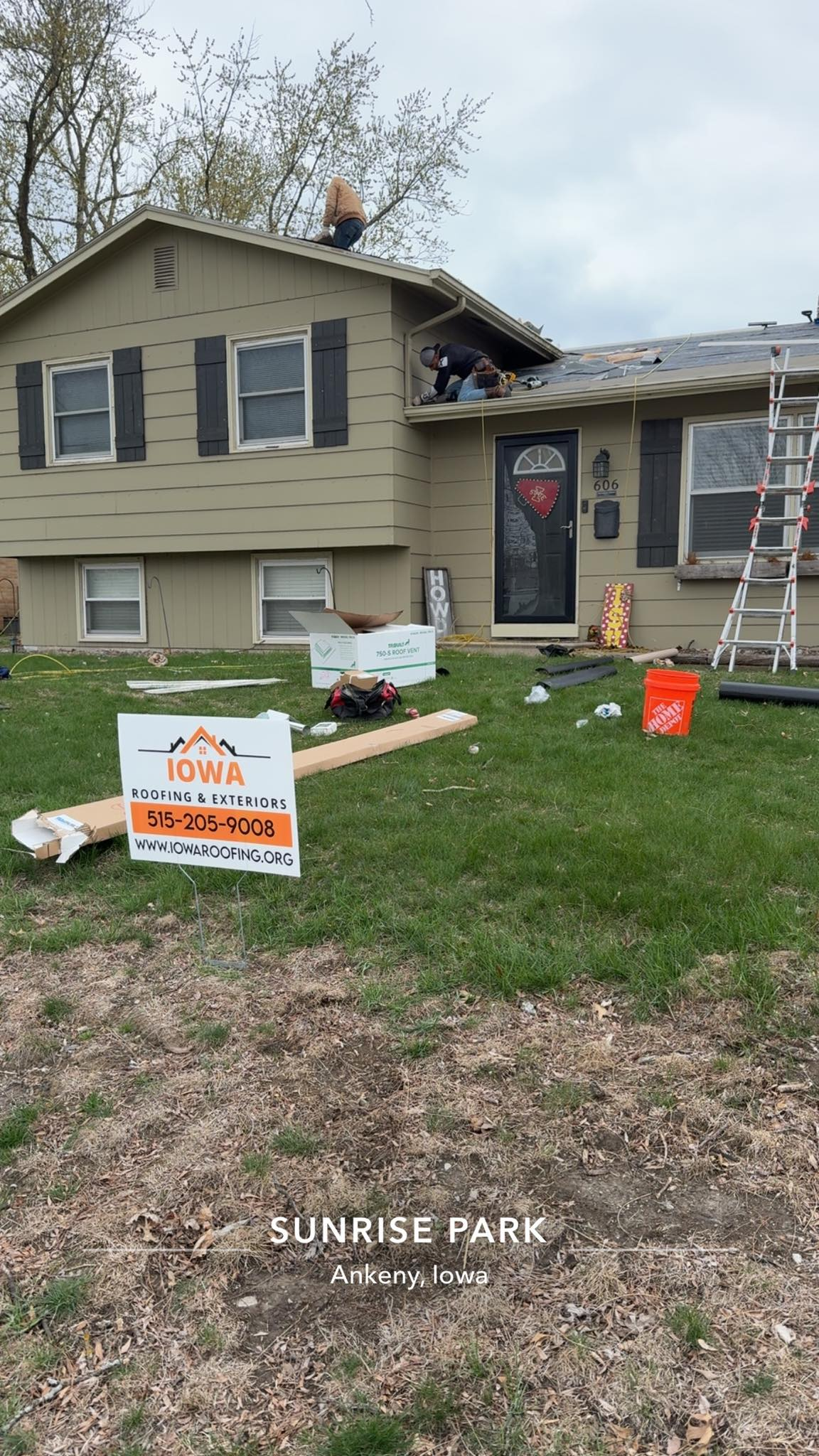Roofer hammers copper flashing onto a shingled roof, wearing gloves.